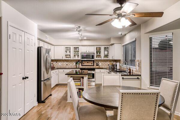 1609 East Mohawk Lane Phoenix, AZ 85024 - Photo 10 of 31 a kitchen with stainless steel appliances granite countertop a refrigerator a stove top oven a sink dishwasher and white cabinets