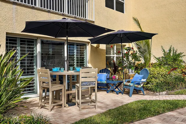 a view of a house with backyard sitting area and swimming pool