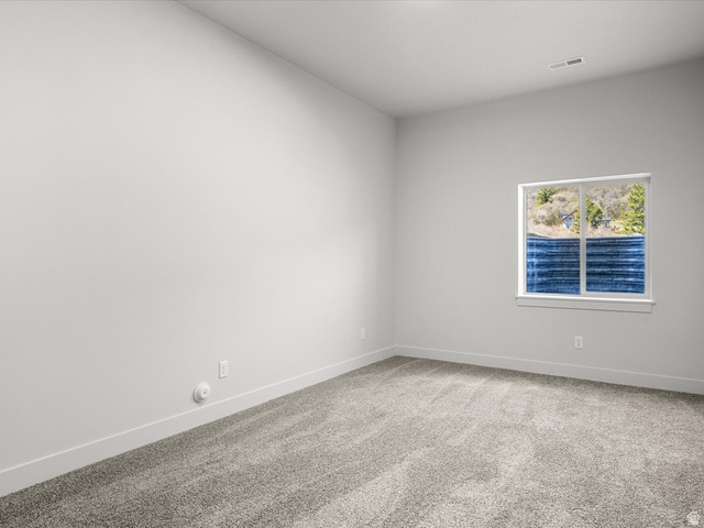 1159 North Broad Hollow Road Garden City, UT 84028 - Photo 55 of 55 Spacious room featuring neutral carpeting, white baseboards, and a large window with white trim