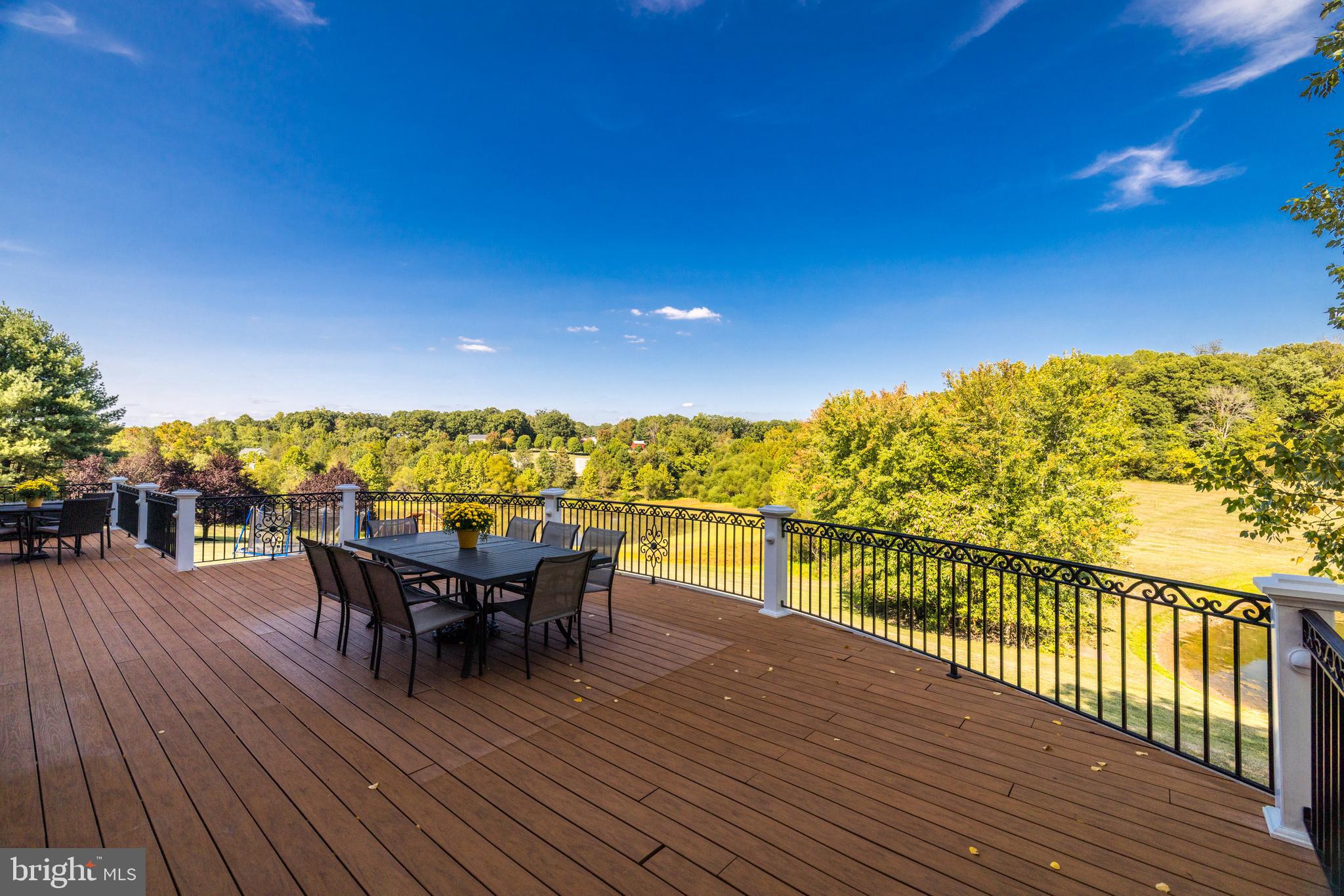 22609 Hillside Circle Leesburg, VA 20175 - Photo 11 of 110 a view of a balcony with dining table & chairs with wooden floor