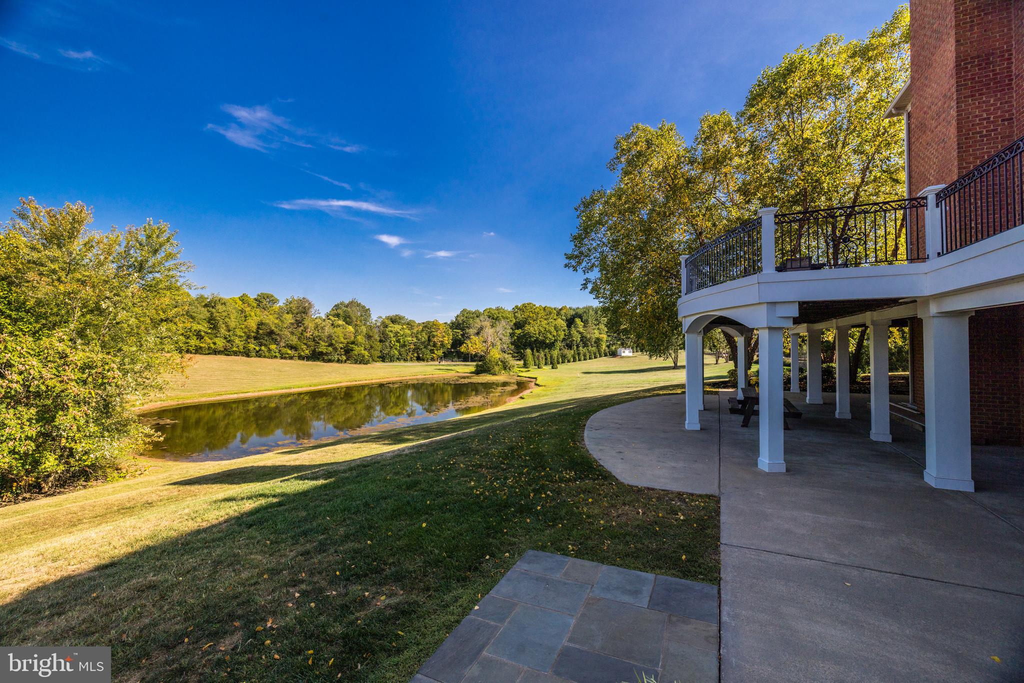 22609 Hillside Circle Leesburg, VA 20175 - Photo 15 of 110 a view of a swimming pool with an outdoor seating and a yard