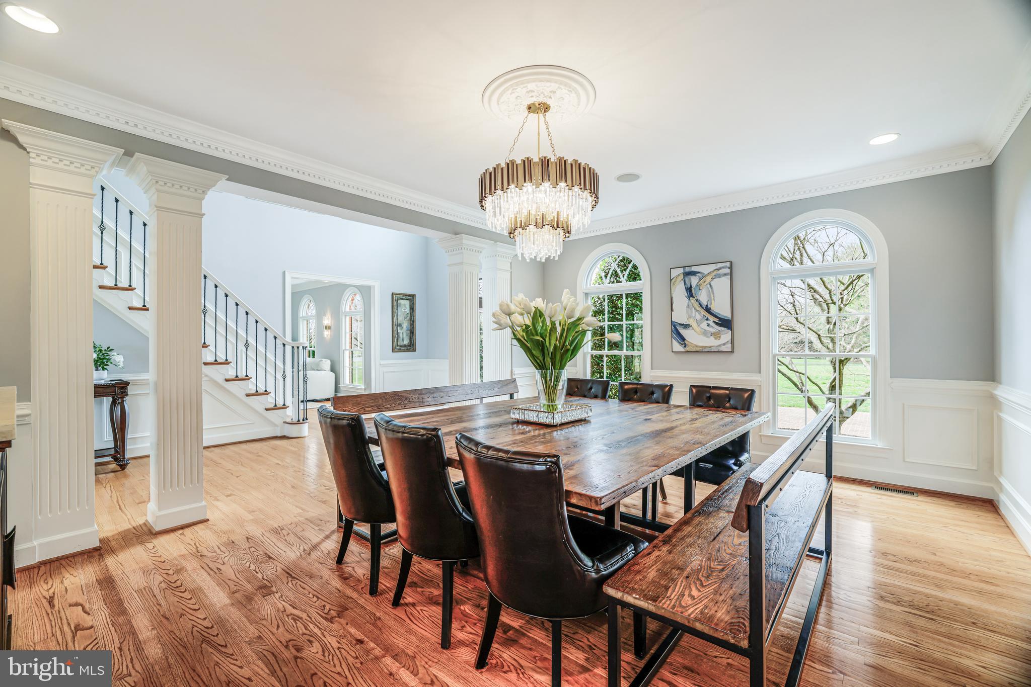 22609 Hillside Circle Leesburg, VA 20175 - Photo 35 of 110 a view of a dining room with furniture a chandelier and wooden floor