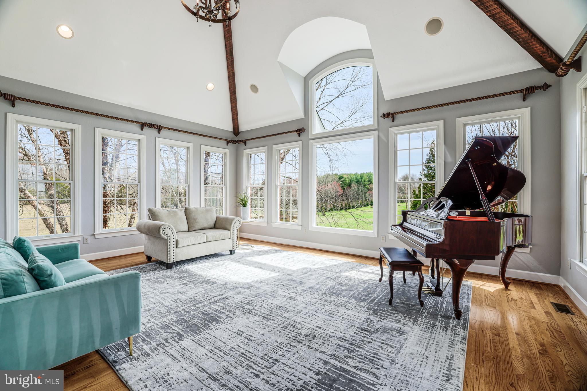 22609 Hillside Circle Leesburg, VA 20175 - Photo 40 of 110 a living room with furniture a rug a floor to ceiling windows and a rug