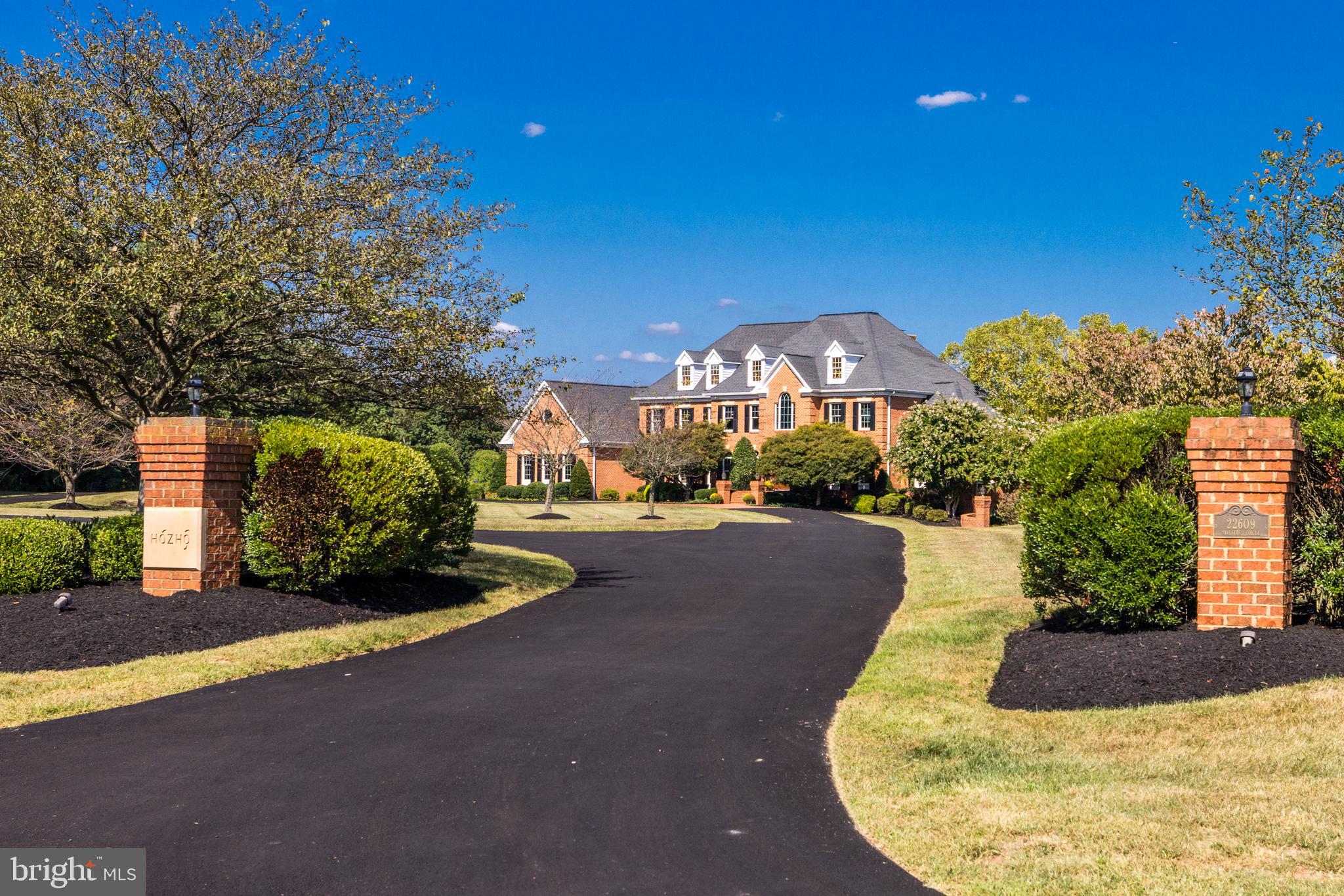 22609 Hillside Circle Leesburg, VA 20175 - Photo 5 of 110 a view of a house with a yard and garage