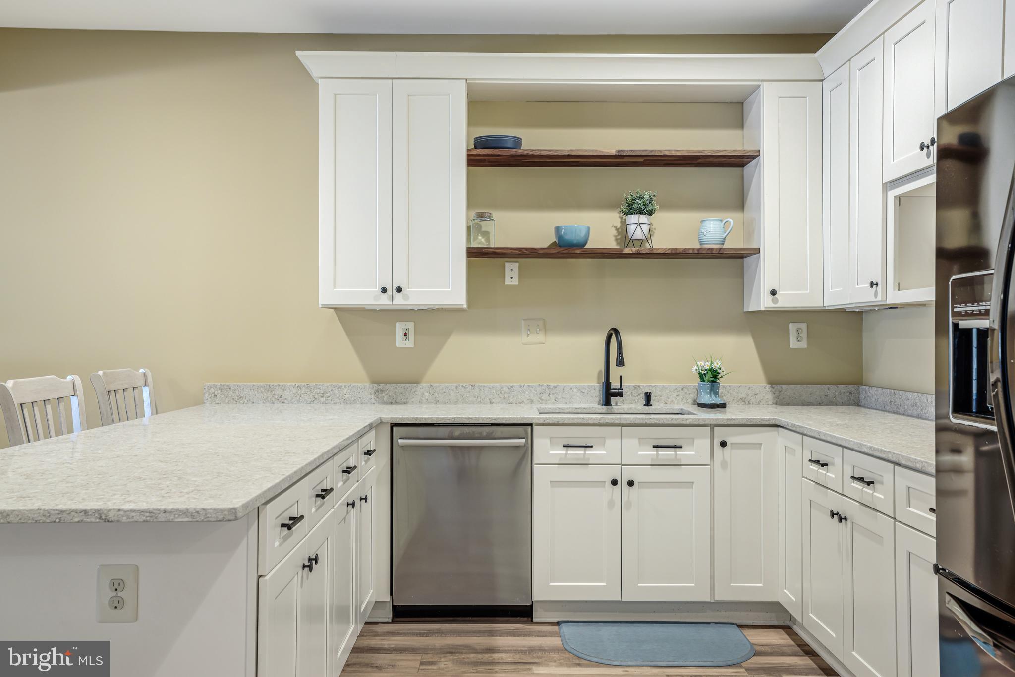 22609 Hillside Circle Leesburg, VA 20175 - Photo 91 of 110 a kitchen with stainless steel appliances granite countertop a sink and dishwasher a stove with wooden floor