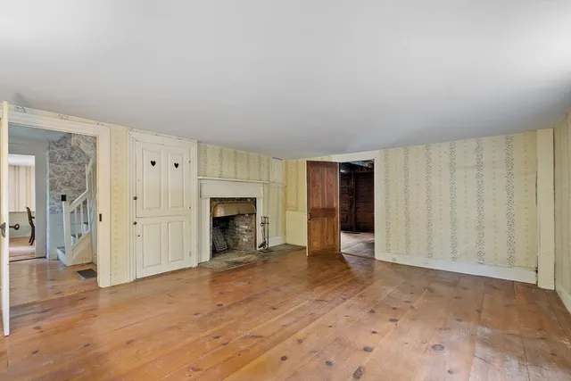 a view of an empty room with a fireplace