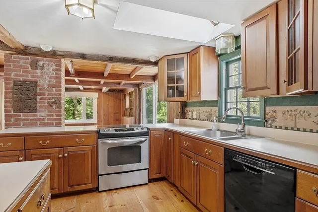 a kitchen with a sink stove and microwave