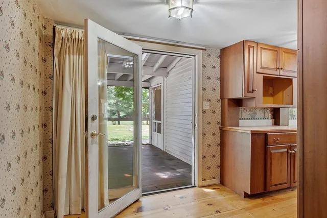 a bathroom with a granite countertop sink a mirror and shower
