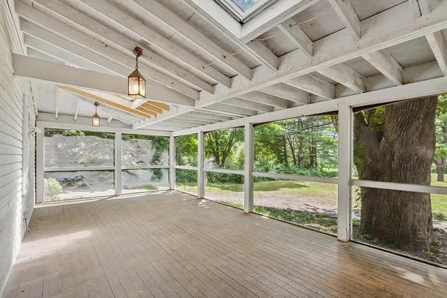 a view of a room with wooden floor and windows
