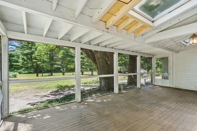 a view of a room with an empty space and wooden floor