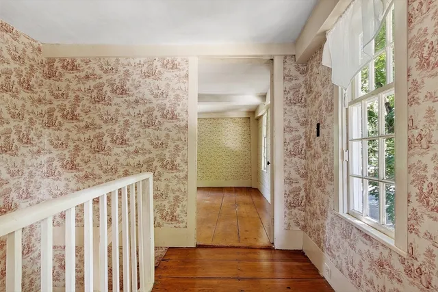 a view of a door with wooden floor and a window