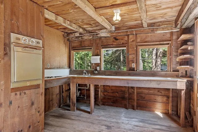 a kitchen with a wooden floor and a window