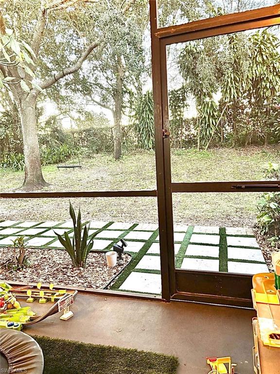 14908 Summit Pl Circle, Unit 26 Naples, FL 34119 - Photo 13 of 26 a view of a balcony with floor to ceiling windows with wooden floor