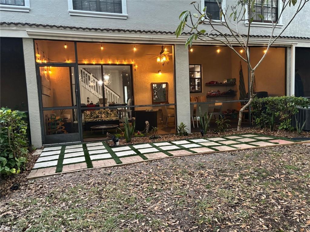 14908 Summit Pl Circle, Unit 26 Naples, FL 34119 - Photo 14 of 26 a view of a porch with a table and chairs