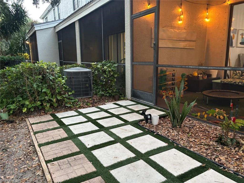 14908 Summit Pl Circle, Unit 26 Naples, FL 34119 - Photo 16 of 26 a backyard of a house with lots of green space