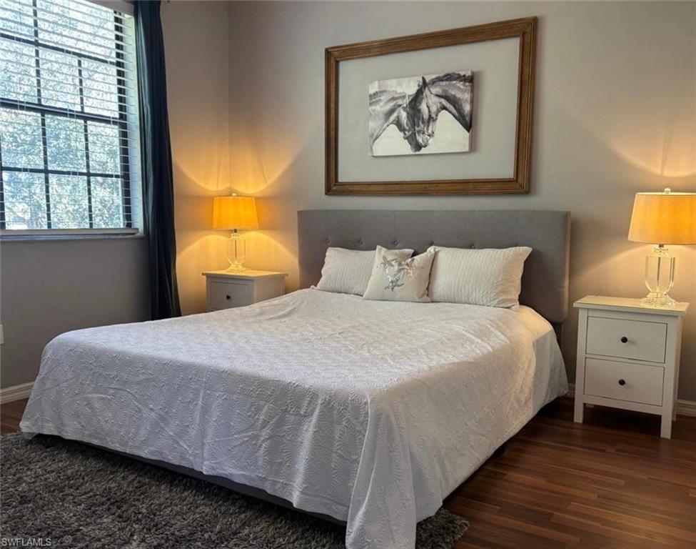 14908 Summit Pl Circle, Unit 26 Naples, FL 34119 - Photo 17 of 26 a bedroom with a bed and a window