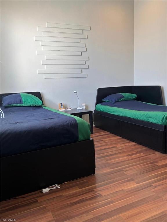 14908 Summit Pl Circle, Unit 26 Naples, FL 34119 - Photo 20 of 26 a bedroom with a bed and a dresser