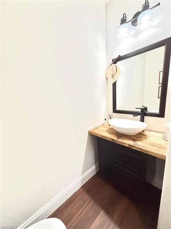 14908 Summit Pl Circle, Unit 26 Naples, FL 34119 - Photo 25 of 26 a bathroom with a sink and a mirror