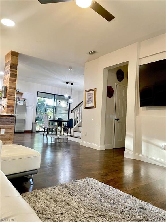 14908 Summit Pl Circle, Unit 26 Naples, FL 34119 - Photo 3 of 26 a living room with furniture and a flat screen tv