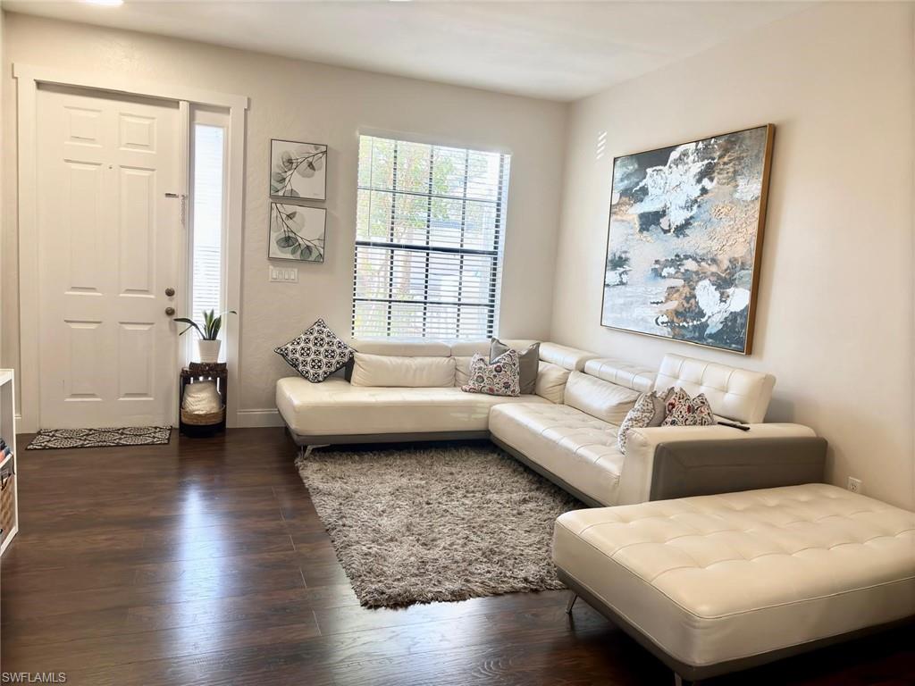 14908 Summit Pl Circle, Unit 26 Naples, FL 34119 - Photo 4 of 26 a living room with furniture and a large window