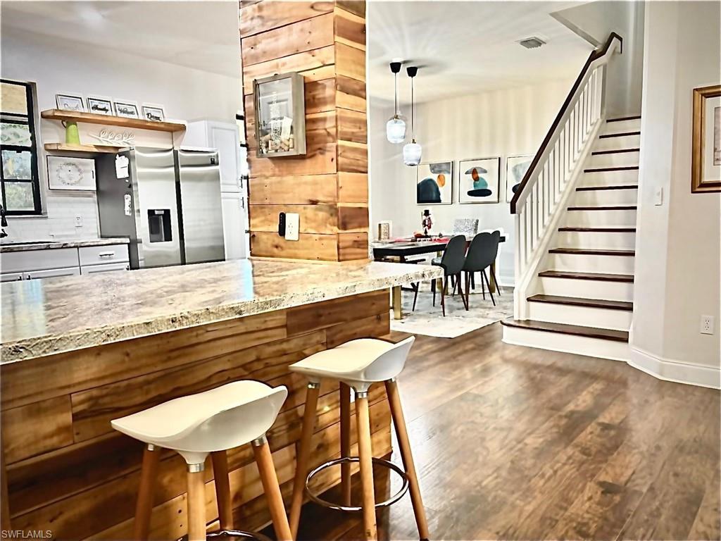 14908 Summit Pl Circle, Unit 26 Naples, FL 34119 - Photo 5 of 26 a view of a dining room with furniture and wooden floor