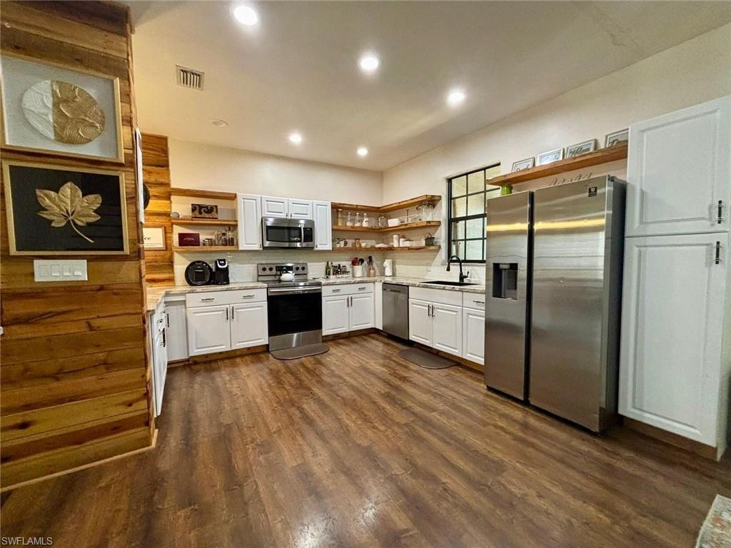 14908 Summit Pl Circle, Unit 26 Naples, FL 34119 - Photo 6 of 26 a kitchen with stainless steel appliances granite countertop a refrigerator and a stove top oven
