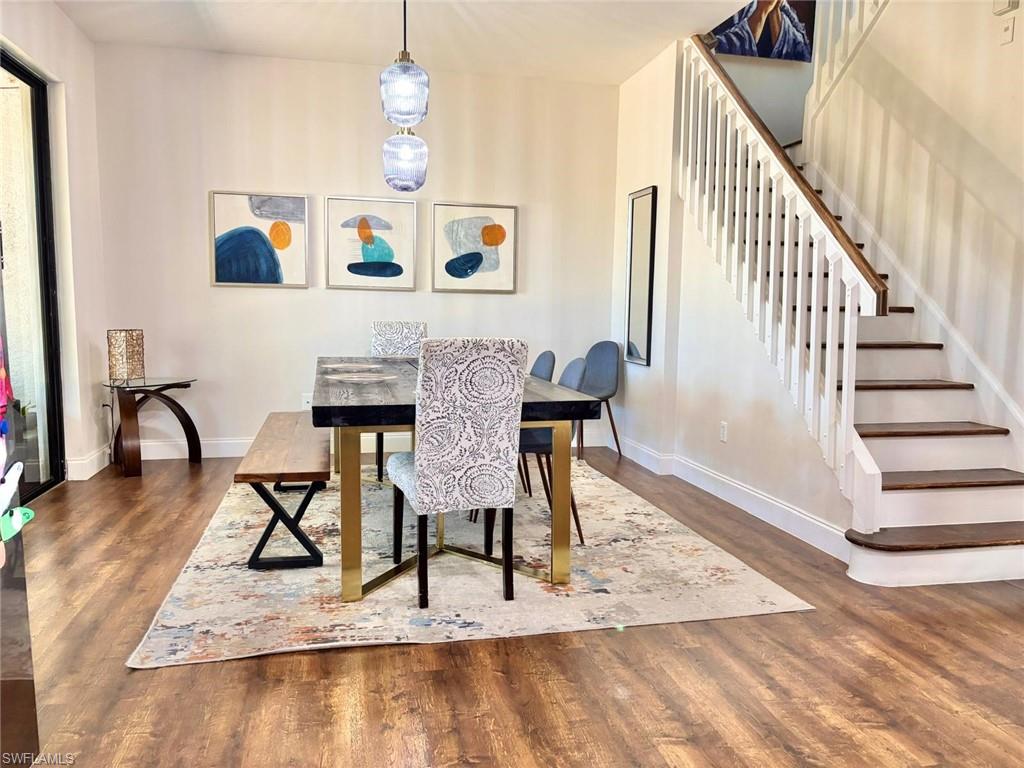 14908 Summit Pl Circle, Unit 26 Naples, FL 34119 - Photo 9 of 26 a view of a dining room with furniture a rug and wooden floor