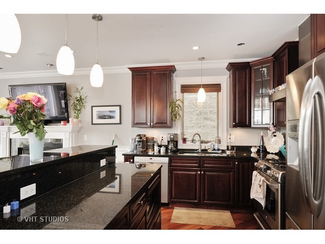 950 West Barry Avenue, Unit 3 Chicago, IL 60657 - Photo 4 of 10 a kitchen with granite countertop a sink cabinets and stainless steel appliances