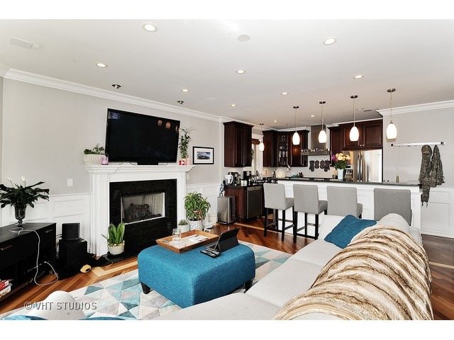 950 West Barry Avenue, Unit 3 Chicago, IL 60657 - Photo 5 of 10 a living room with furniture fireplace and flat screen tv