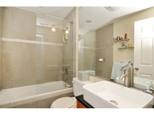 950 West Barry Avenue, Unit 3 Chicago, IL 60657 - Photo 10 of 10 a bathroom with a tub a sink and a shower
