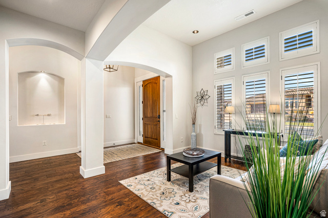 2311 South 1340 West St. George, UT 84770 - Photo 10 of 56 Living area with arched walkways and dark wood finished floors