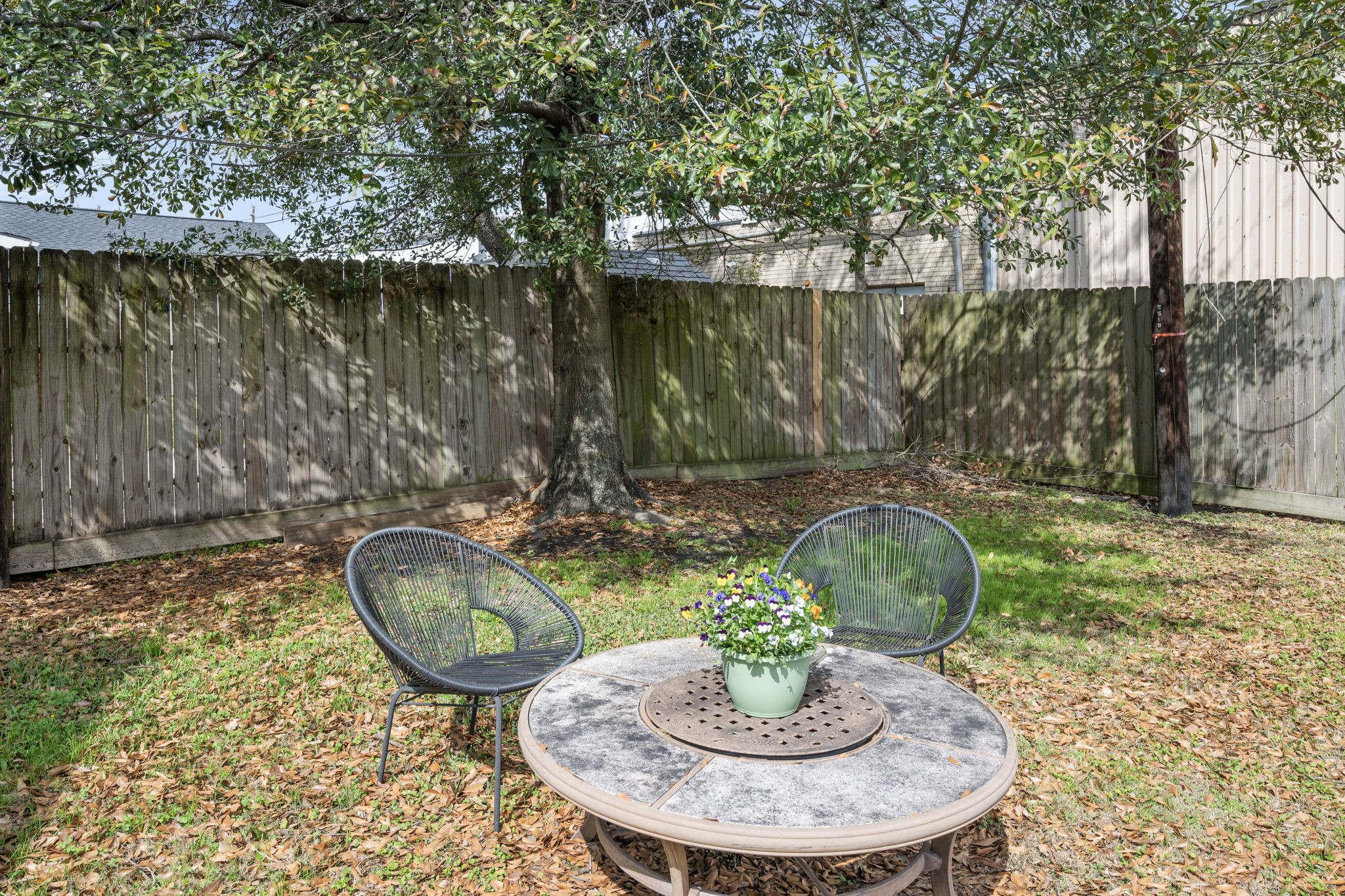 5519 Hillman Street Houston, TX 77023 - Photo 18 of 22 a backyard with table and chairs and a fire pit
