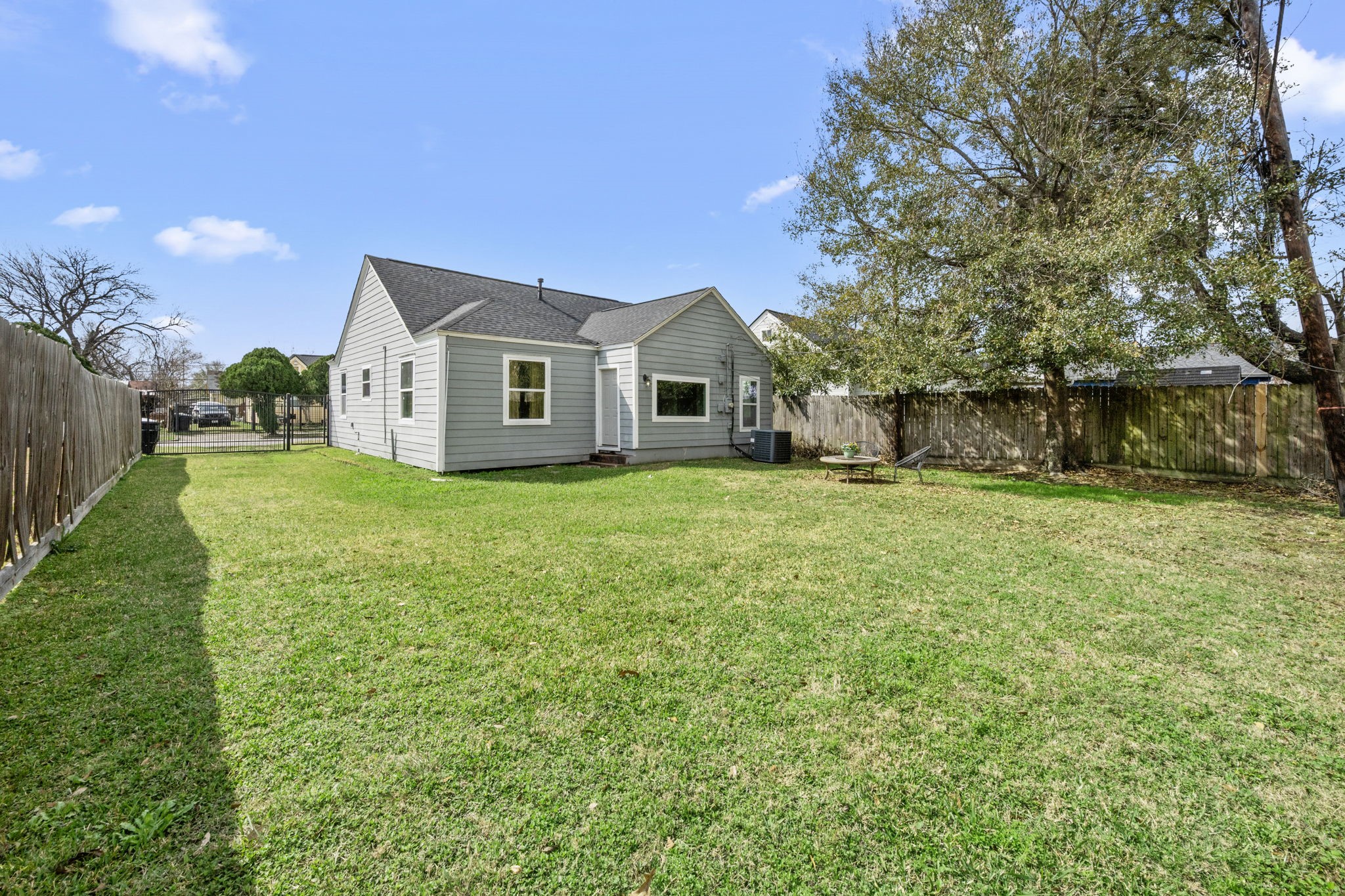 5519 Hillman Street Houston, TX 77023 - Photo 19 of 22 a view of a house with a big yard and large trees