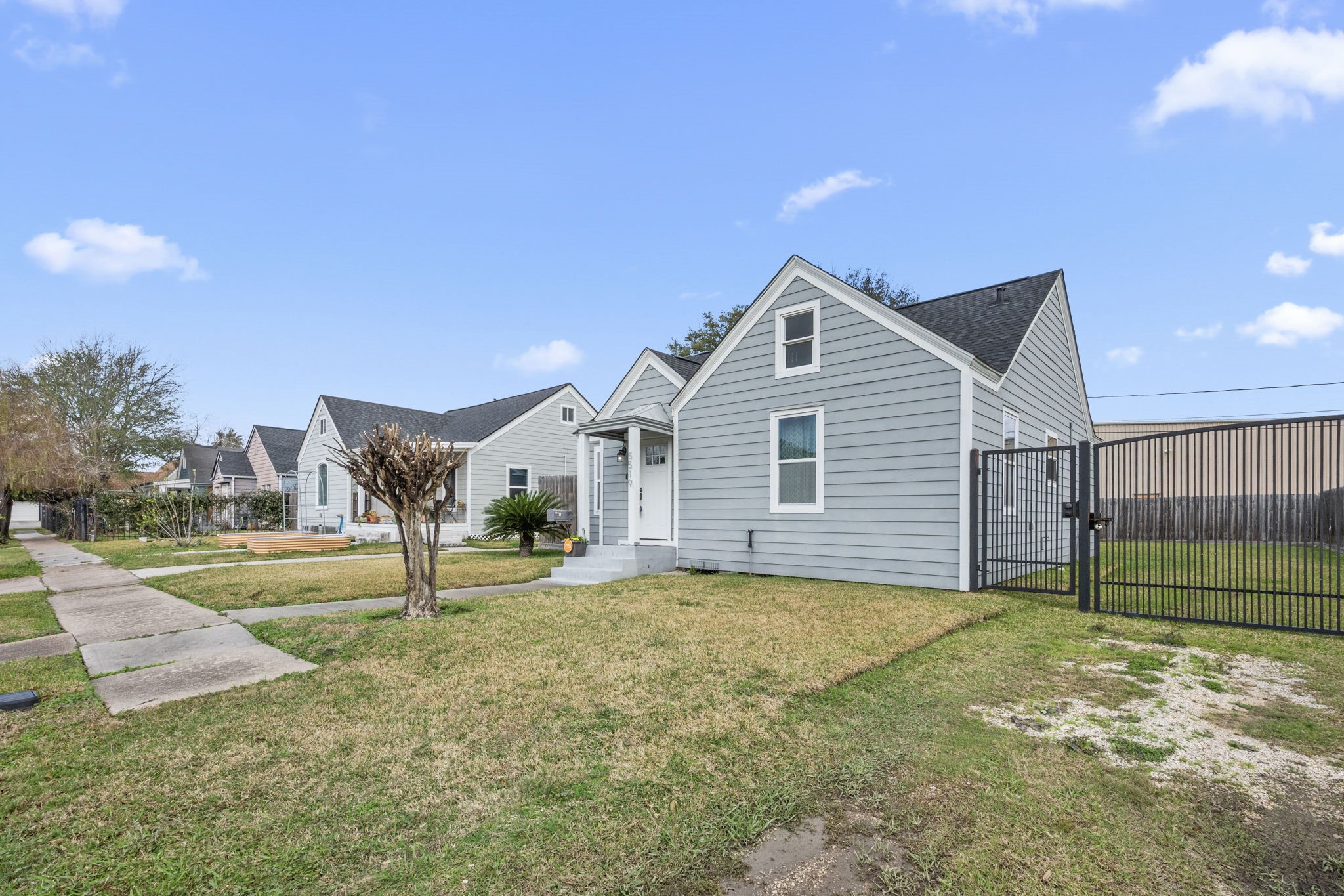 5519 Hillman Street Houston, TX 77023 - Photo 20 of 22 a front view of a house with a yard