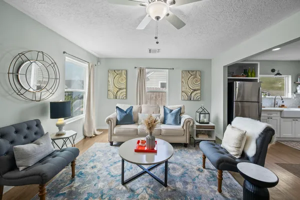 a living room with furniture and a chandelier