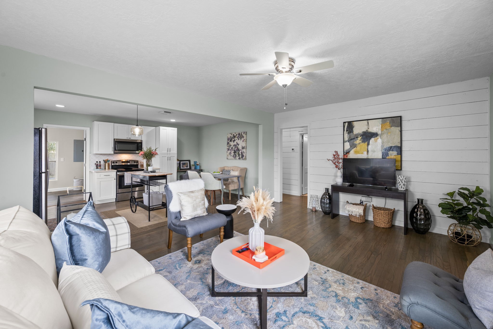 5519 Hillman Street Houston, TX 77023 - Photo 5 of 22 a living room with furniture and a dining table with wooden floor