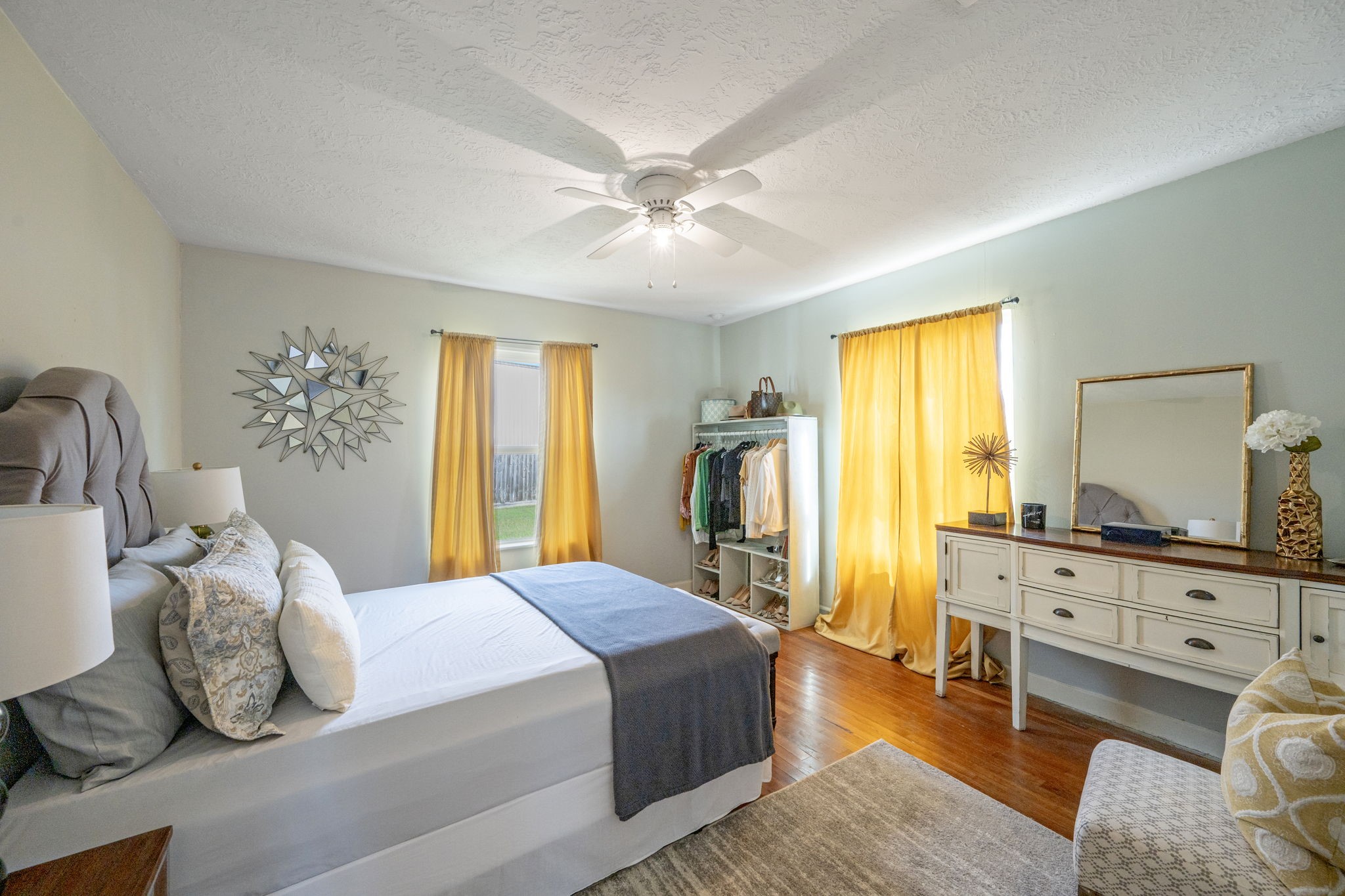 5519 Hillman Street Houston, TX 77023 - Photo 9 of 22 a spacious bedroom with a bed and wooden floor