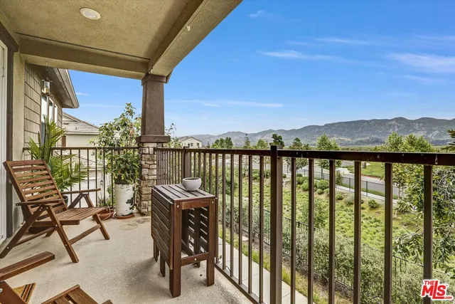 a view of a chairs and table in the balcony