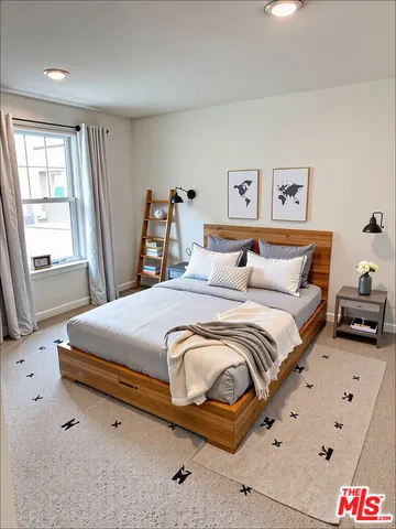 a bedroom with a bed and window