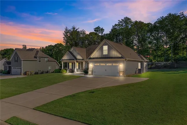 a front view of a house with a yard and garage
