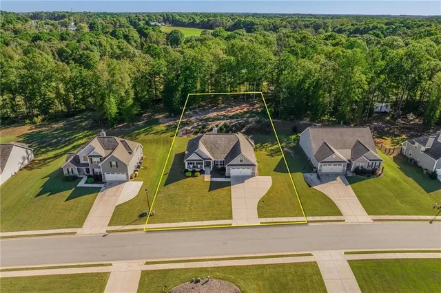 an aerial view of house with yard swimming pool and outdoor seating
