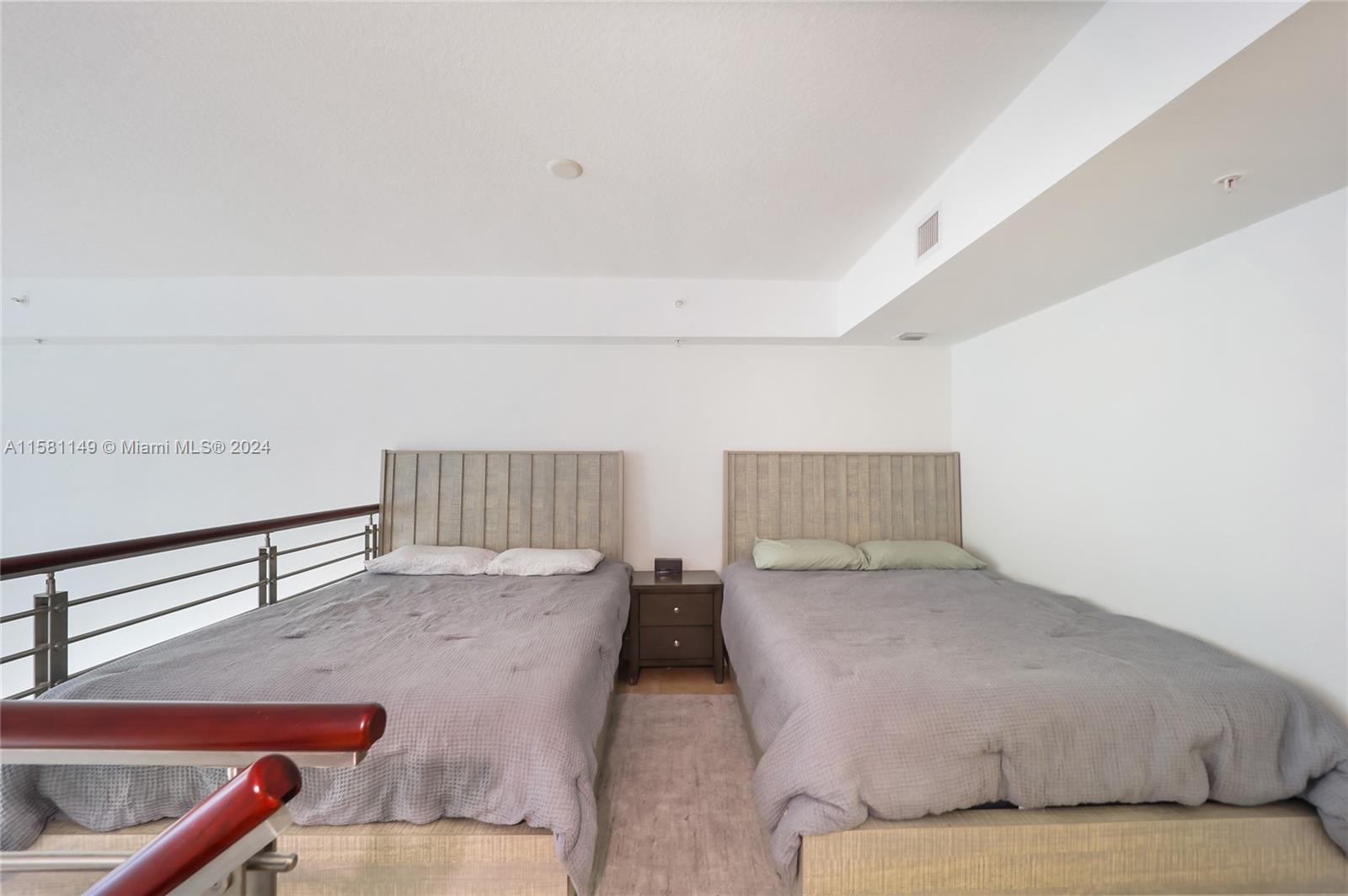 41 Southeast 5th Street, Unit 304 Miami, FL 33131 - Photo 9 of 16 a bedroom with a bed and window