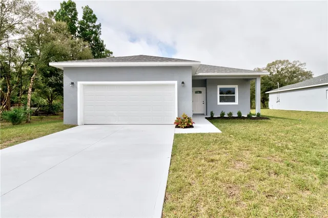 a view of a house with a yard and garage