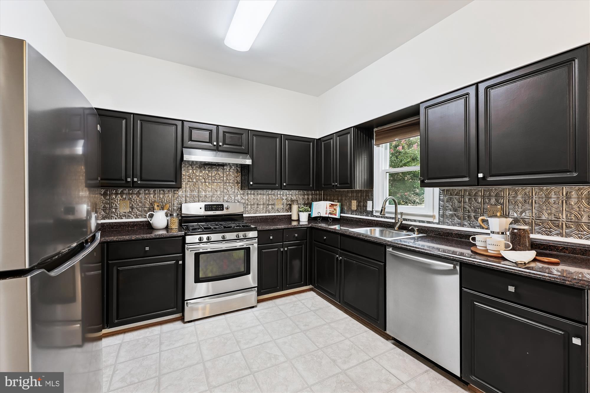 473 Tschiffely Square Road Gaithersburg, MD 20878 - Photo 11 of 64 a kitchen with a sink stove and microwave