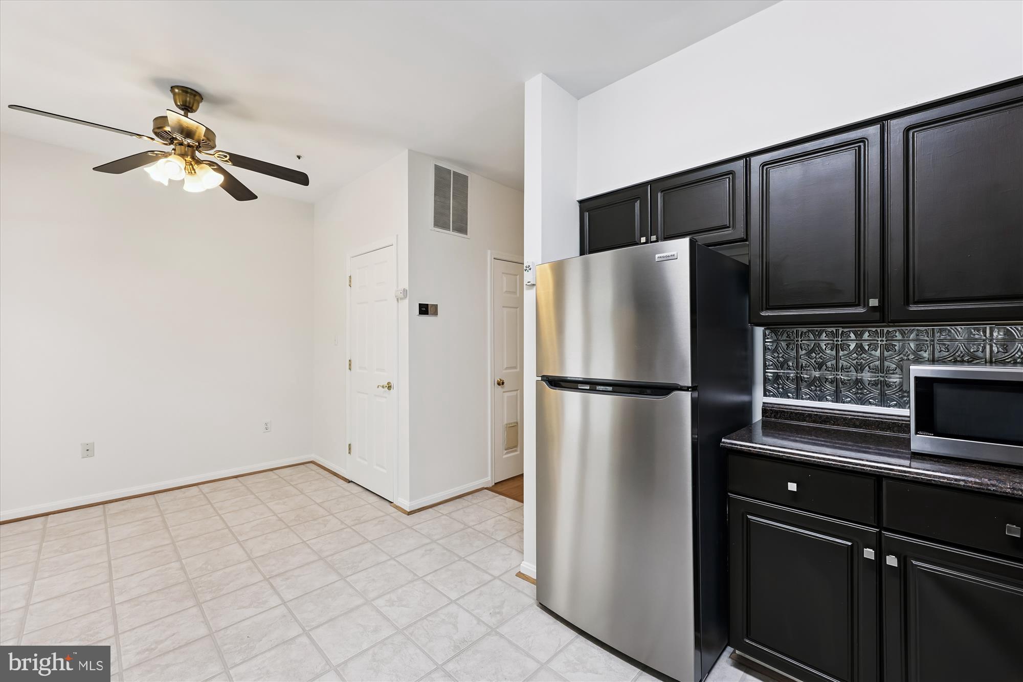 473 Tschiffely Square Road Gaithersburg, MD 20878 - Photo 12 of 64 a white refrigerator freezer and a stove sitting inside of a kitchen