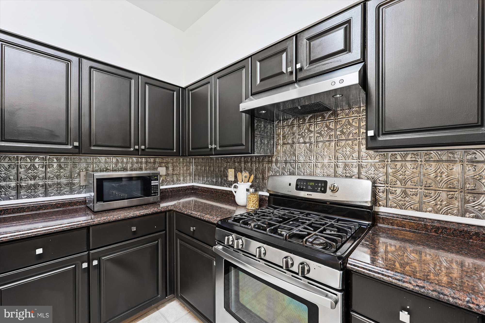 473 Tschiffely Square Road Gaithersburg, MD 20878 - Photo 13 of 64 a kitchen with a stove a sink and cabinets