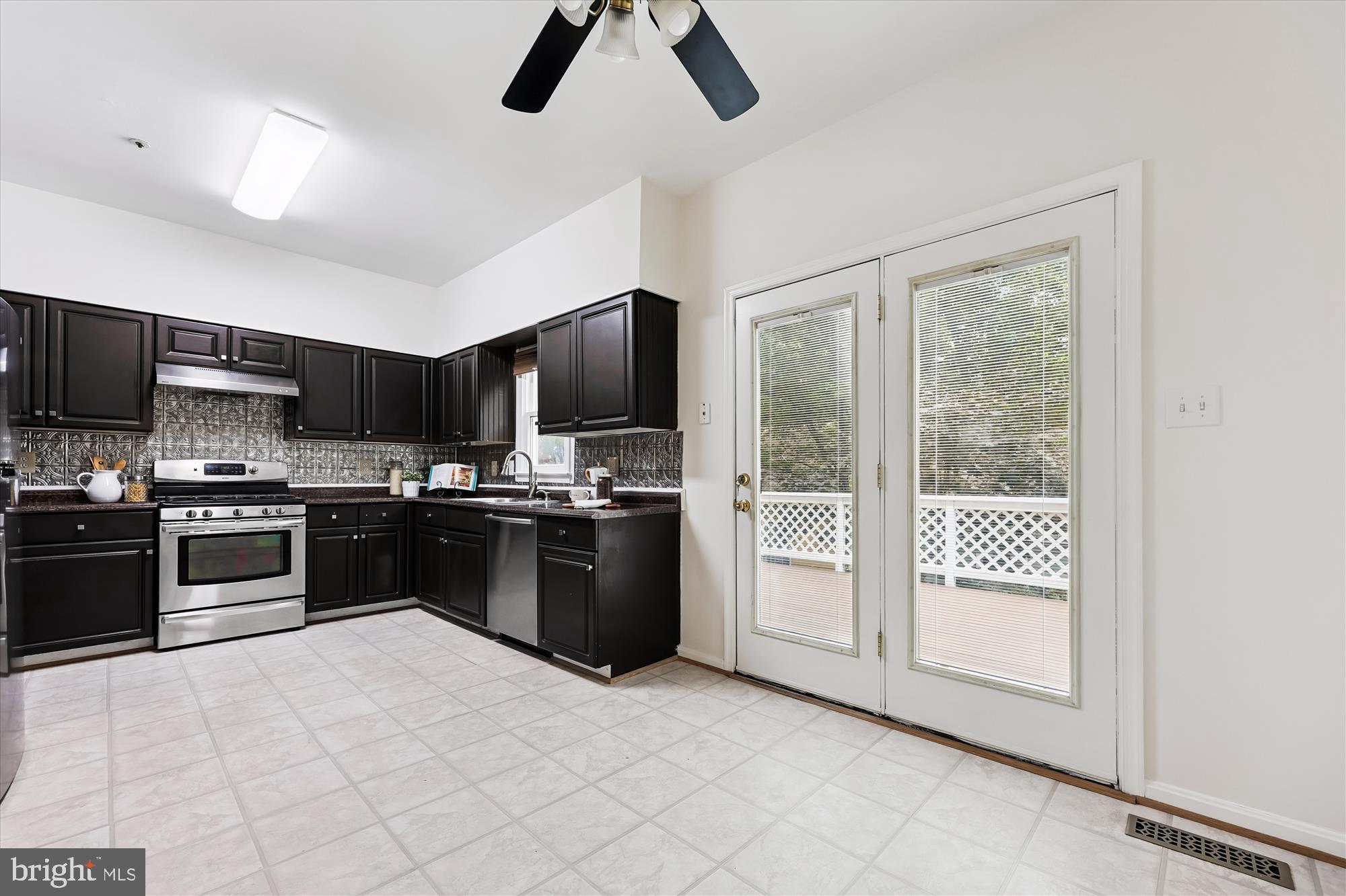 473 Tschiffely Square Road Gaithersburg, MD 20878 - Photo 15 of 64 a large kitchen with cabinets and stainless steel appliances