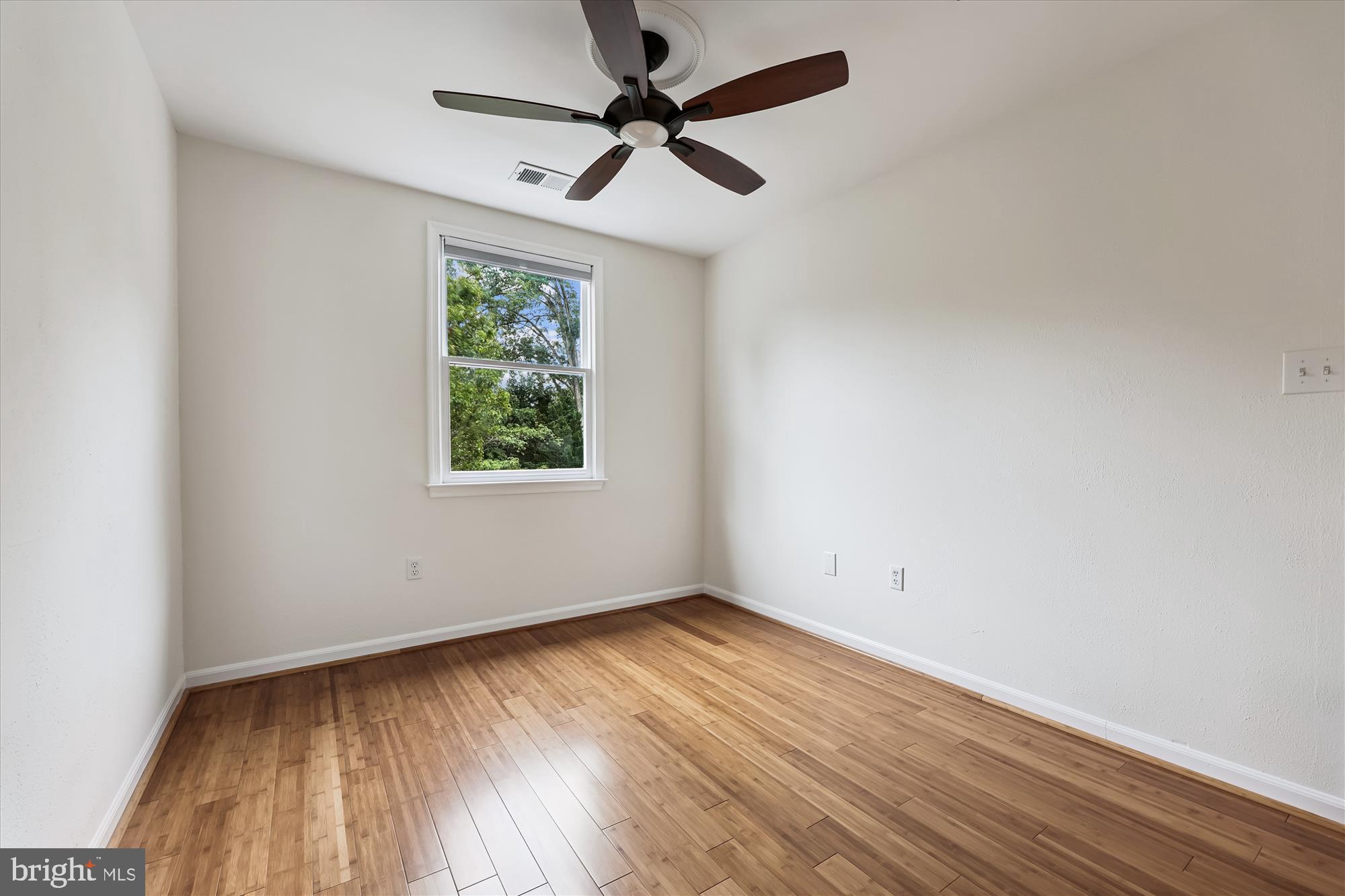 473 Tschiffely Square Road Gaithersburg, MD 20878 - Photo 26 of 64 an empty room with wooden floor ceiling fan and windows