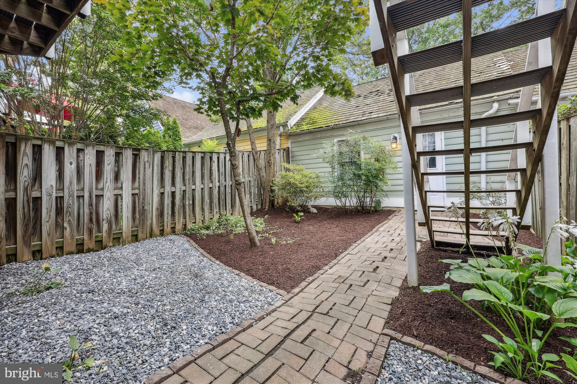 473 Tschiffely Square Road Gaithersburg, MD 20878 - Photo 48 of 64 a view of a backyard with wooden fence and plants