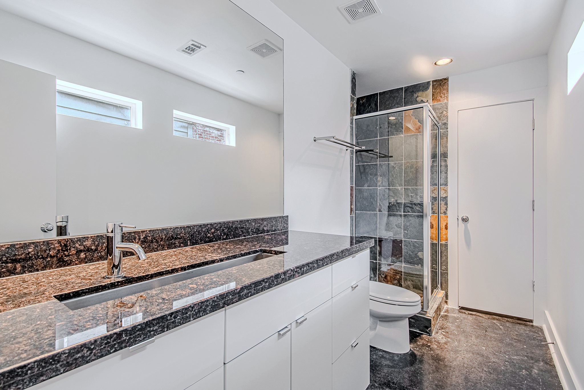 2025 Colquitt Street, Unit E Houston, TX 77098 - Photo 8 of 29 Modern kitchen with sleek cabinetry, long countertops, and a clean, streamlined layout.